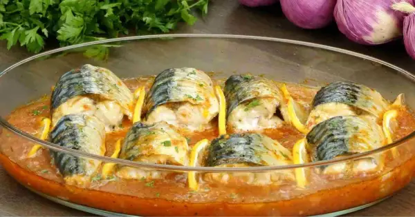 Maquereaux au four, tendres et savoureux, baignant dans une sauce tomate parfumée, accompagnés de quartiers de citron.
