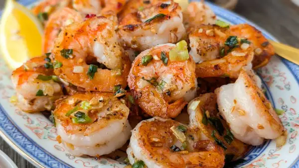Crevettes sautées chinoises, parfumées à l'ail et à la ciboule, servies avec un quartier de citron. Un délice !